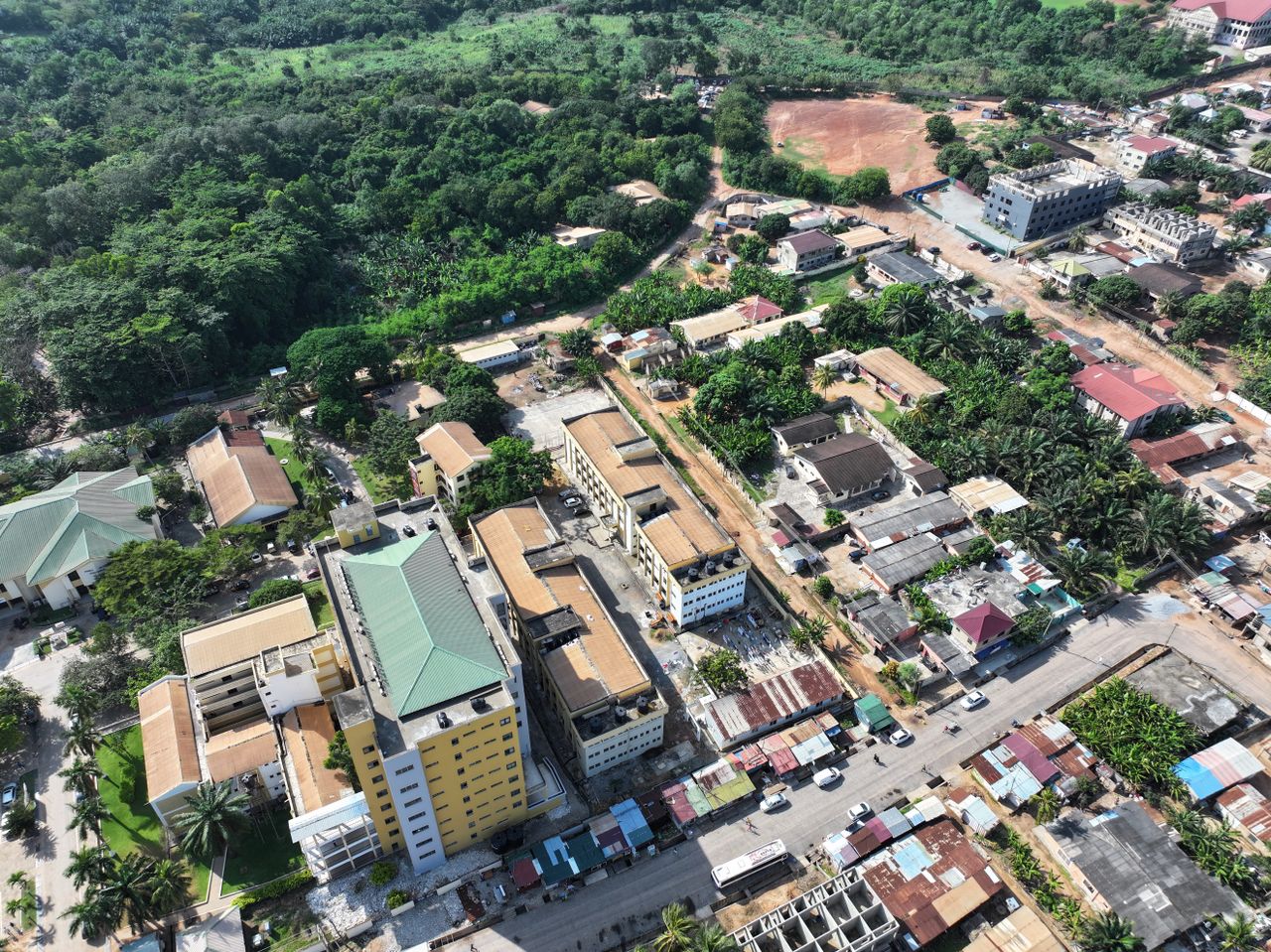 about-01 Aerial view over Sowutoum, Ghana showcasing residential areas and lush greenery.